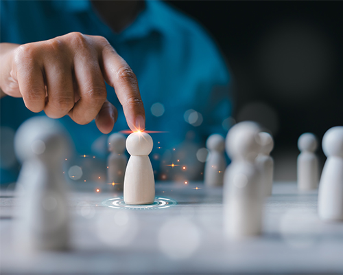 Businessman choosing wooden figure hiring, business tactics and strategy. Leadership of business success. Organization development. Personnel selection. Human resource management concept.